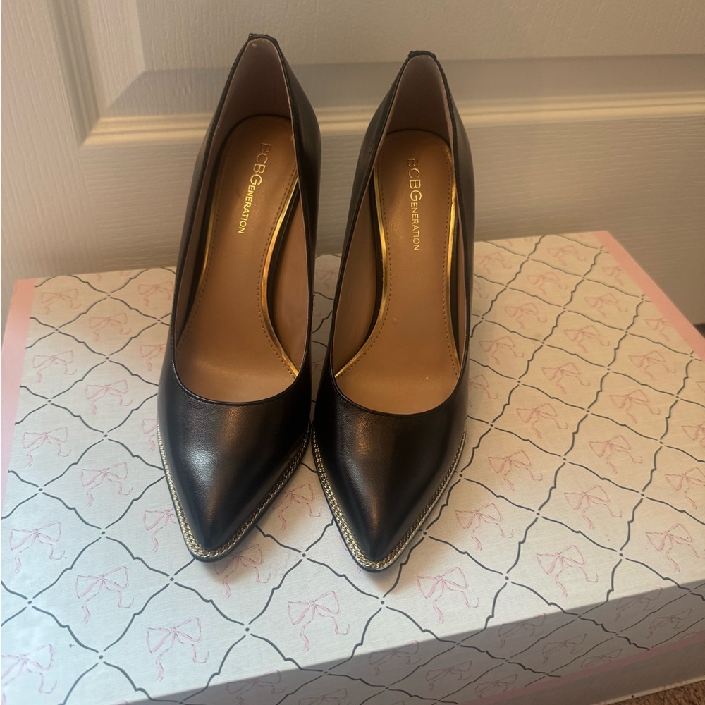 BCBGeneration Black Pointed Toe Pumps with Gold Trim